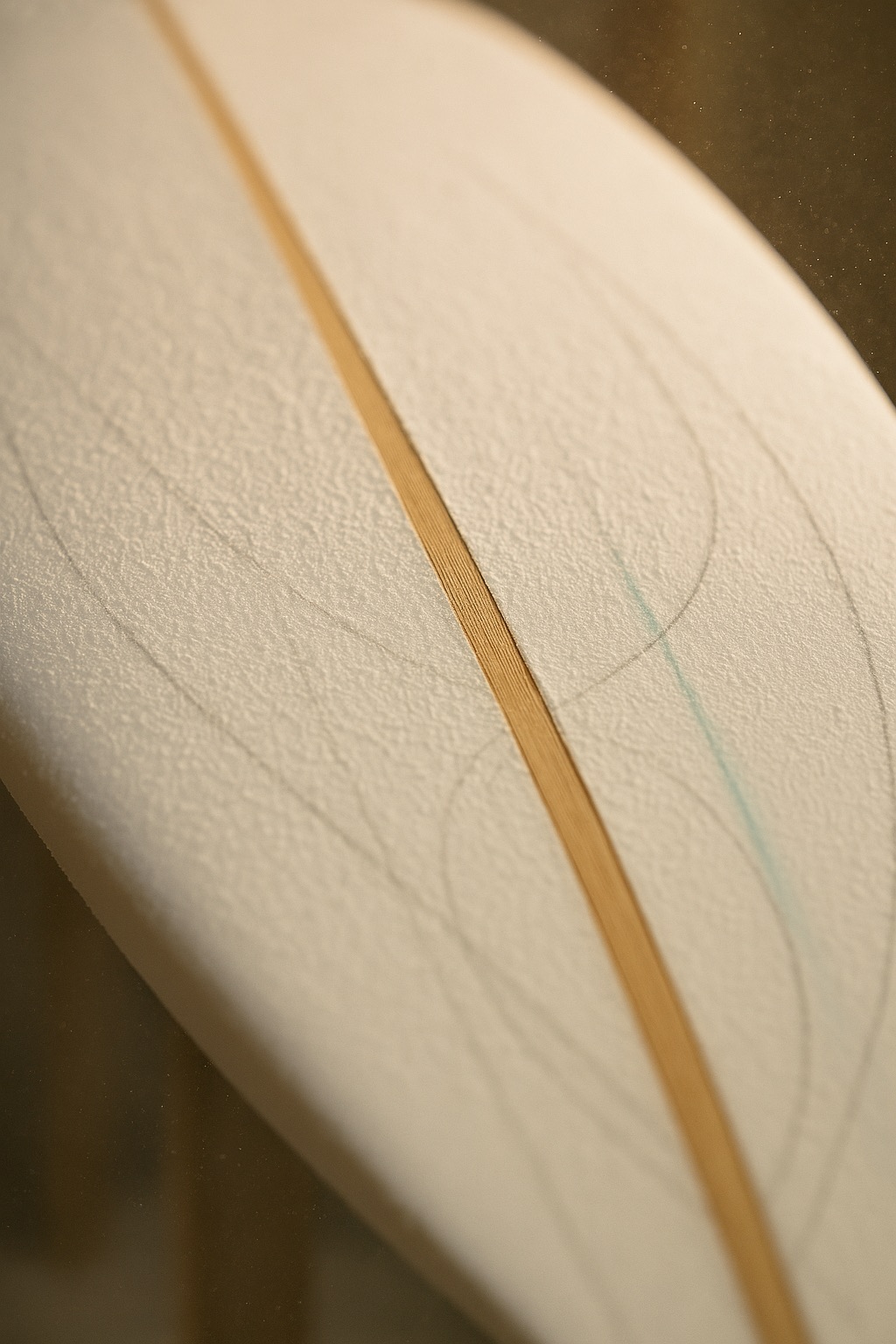 Close view of a basswood stringer line running down the centre of a bare white foam blank with faint pencil template marks.
